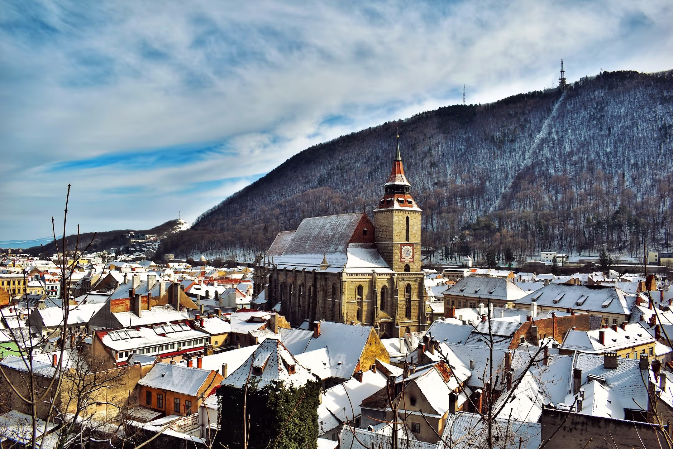Snow-covered Piața Sfatului and the Black Church in Brașov during winter