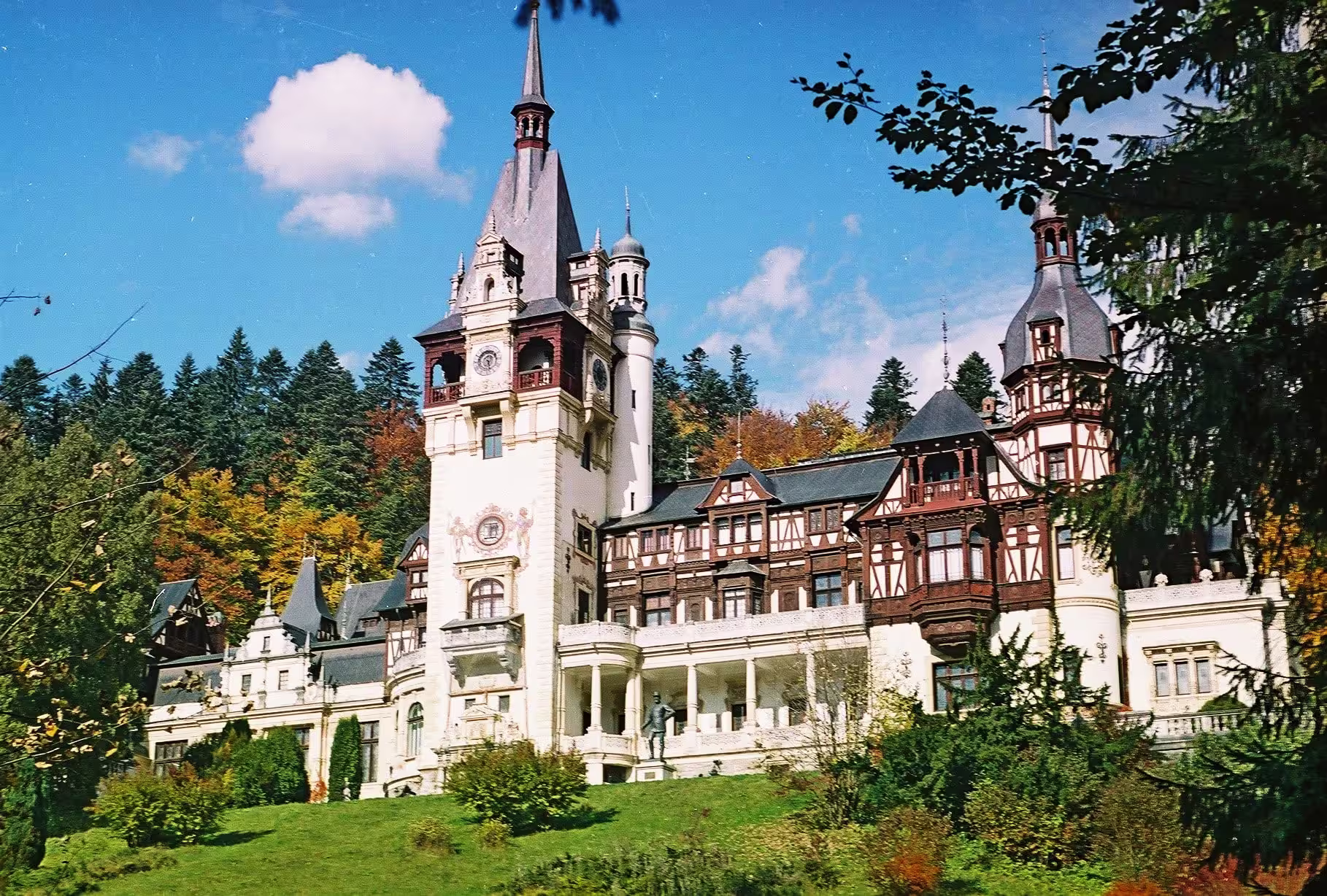 Peleș Castle in Sinaia surrounded by Carpathian forest