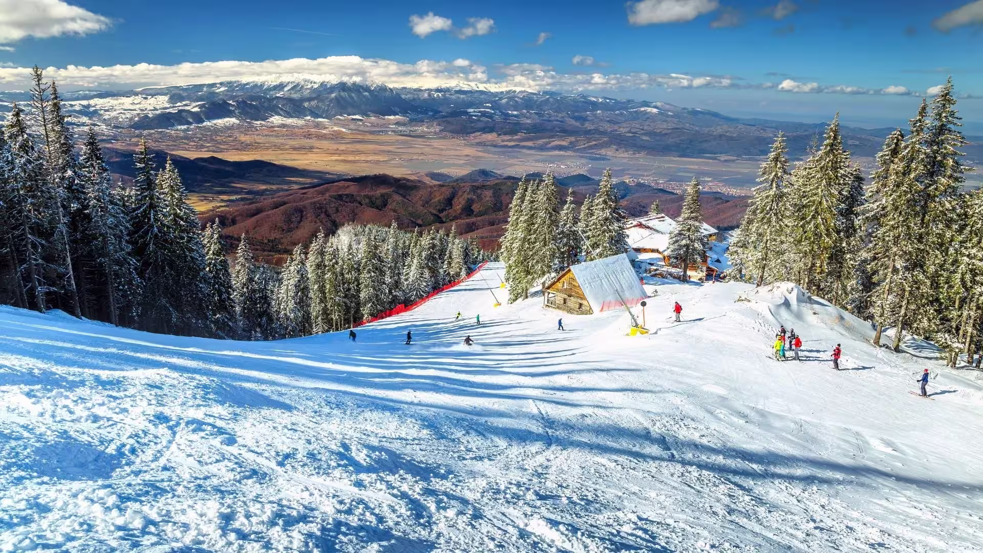 Ski slopes at Poiana Brașov resort with Carpathian mountains in the background